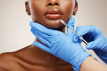 Image showing Closeup, black woman and needle with plastic surgery, healthcare and cosmetics on a white studio background. African person, girl and model with injection, hands and gloves with wellness and skincare