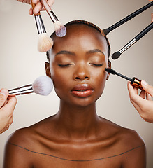 Image showing Makeup, brushes and black woman with cosmetics, skincare and dermatology on grey studio background. African person, wellness or model with tools, grooming and treatment with luxury or shine with glow