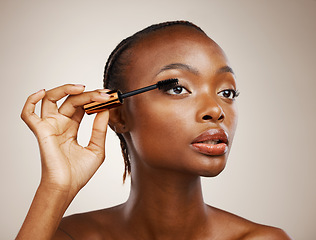 Image showing Mascara, black woman and makeup for beauty cosmetics, makeover and eyelash extension in studio on brown background. Face, model and brush lashes for volume, skincare application and aesthetic tools