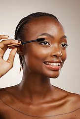 Image showing Mascara, happy woman and makeup in studio for beauty, cosmetics and smile on brown background. African model, makeover and brush lashes for skincare application, aesthetic tools and eyelash extension