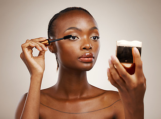 Image showing Black woman, mascara with brush and mirror for beauty, makeup and shine isolated on brown background. Eyelash extension, wand and skin glow with cosmetology, transformation and wellness in studio