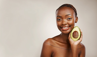 Image showing Avocado, beauty and portrait of woman in studio for detox, mockup space and background. Face of happy african model, natural skincare and fruit for vegan cosmetics, sustainable diet or benefits