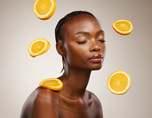 Image showing Black woman, skincare and face with orange, vitamin c and cosmetics for healthy skin, eyes closed and facial treatment. Wellness, glow and dermatology for natural ingredients, vegan care and citrus