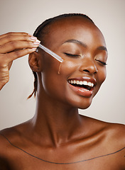 Image showing Happy woman, skincare and serum on face in studio for beauty, dermatology or collagen on brown background. African model, facial cosmetics and liquid dropper of hyaluronic acid, essential oil or glow