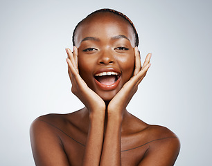 Image showing Portrait, skincare and hands on the cheek of a black woman in studio on a gray background for beauty or natural wellness. Face, spa or luxury and a young model with cosmetic or antiaging treatment