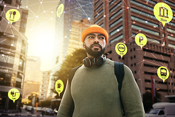 Image showing Travel, hologram or overlay and man walking in a city as a tourist with an icon interface to highlight a hotspot. Hologram map, direction or navigation with a young person in an urban town location