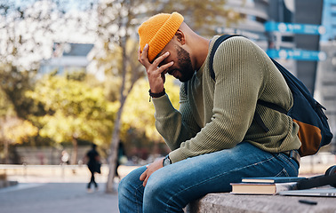 Image showing Stress, headache and student outdoor in college, campus or city with anxiety, crisis or problem in education. Frustrated, man or depressed in university with mistake, fail or fatigue from studying