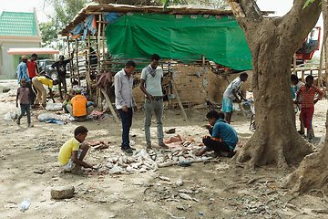 Image showing The men sort the remaining fish after closing the fish market. Ethiopia