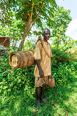 Image showing Ethiopian farmer with a bee hive and an primitive ax, Southern Nations , Ethiopia