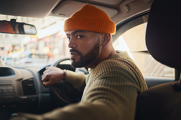 Image showing Taxi, ride and man driving in a car as city transport or vehicle travel to a destination in town and looking for parking. Serious, back and person in lift service reverse in a street or location