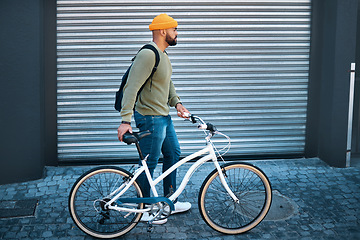 Image showing City, walking and man with bicycle in street for eco friendly transport to university in morning. Urban sidewalk, carbon neutral commute and college student with bike, backpack and morning travel.