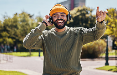 Image showing Music, headphones and portrait of happy man at park outdoor, listening to audio online or hearing sound on podcast technology. Face, streaming radio and person dance in garden for freedom in nature