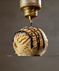 Image showing chocolate sauce pouring on ice cream