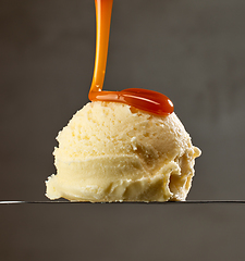 Image showing caramel sauce pouring on vanilla ice cream