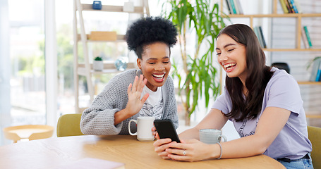 Image showing Women friends, video call and phone in coffee shop, wave and excited for conversation, talk and contact. Girl, smartphone and smile together for communication, social media app and relax with tea cup