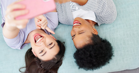 Image showing Above, women and happy selfie on bed with friends in social media, profile picture or post on blog with influencer. Portrait, smile and girls together in home or bedroom with funny emoji or face