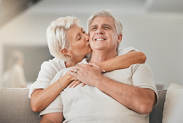 Image showing Happy senior couple, kiss and hug on sofa in living room for embrace, love or affection at home. Mature woman kissing and hugging man with smile in care, trust or support on lounge couch in house