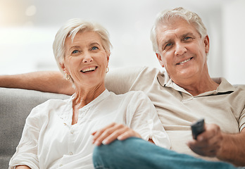 Image showing Happy senior couple, watching TV and relax on sofa for living room entertainment or streaming at home. Mature man and woman smile for series, shows or channels with remote on lounge couch in house
