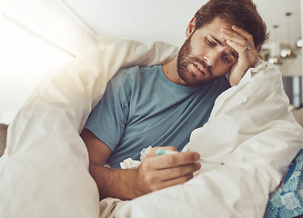 Image showing Thermometer, stress and sick man on a sofa with headache, fever or influenza crisis in his home. Anxiety, high temperature and male person with vertigo, risk or fear of covid infection in living room