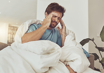 Image showing Stress, headache and sick man on a sofa with burnout, vertigo or pain from insomnia at home. Anxiety, migraine and male person in a lounge with temple massage for dizziness, congestion or head cold