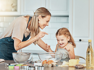 Image showing Mom, girl kid and teaching for baking, development and laugh with bonding, love and care in family home. Cooking, funny mother and daughter with bowl, flour or eggs on table, kitchen or help for food