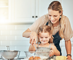 Image showing Mom, girl child and teaching with whisk, development and skills with baking, love and care in family home. Cooking, mother and daughter with smile, flour and eggs on table, kitchen and help for food