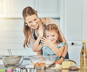 Image showing Mom, girl child and teaching for cooking, development and skills with bonding, love and care in family home. Baking, mother and daughter with smile, flour and eggs on table, kitchen and help for food