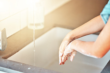 Image showing Soap, washing hands and kid with water for cleaning, hygiene and wellness in bathroom at home. Health, child development and palms of young girl with foam for protection for germs, virus and bacteria