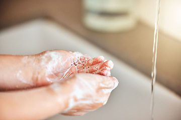 Image showing Soap, washing hands and kid by sink for cleaning, hygiene and wellness in bathroom at home. Health, child development and palms of young girl with water for protection for germs, virus and bacteria