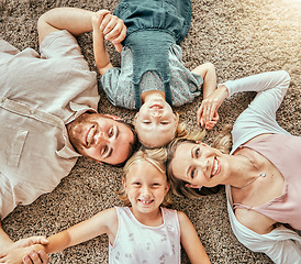 Image showing Happy, portrait and children with parents in living room bonding and relaxing together at home. Happiness, love and girl kids lay with mother and father from Australia on floor in lounge from above.