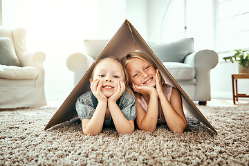 Image showing Portrait, children and cardboard for insurance with girl sisters on the floor of the living room at home. Security. family or kids and young siblings on a carpet in their house for safety with flare