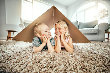 Image showing Smile, kids and cardboard for insurance with girl sisters on the floor of the living room at home. Security. family or children and young siblings on a carpet in their house for safety with flare