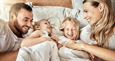 Image showing Top view, bed and happy family bond with tickle, games and laughing in their home together. Bedroom, fun and above parents with girl kids in a house with care, support and love, security or playing