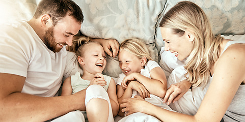 Image showing Love, top view and happy family waking up laughing, playing and bond with tickle games in their home. Bedroom, fun and above children playing with parents in a house with care, support and security