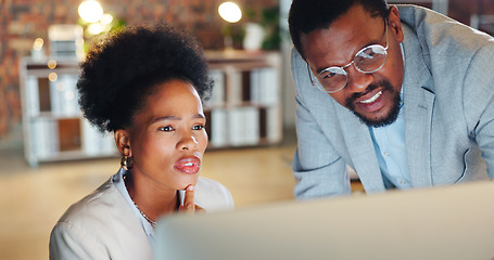 Image showing Teamwork, problem solving and a mentor with an employee in the office at night for project management. Computer, collaboration or planning with a confused business man and woman working together