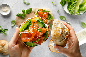 Image showing Salmon sandwiches with cream cheese, fresh romaine lettuce and cucumber, top down view