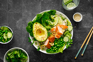 Image showing Salmon avocado bowl with broccoli, green peas, rice and fresh salad. Healthy food, top view