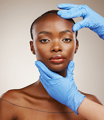 Image showing Portrait, hands and plastic surgery with face of a black woman in studio on a gray background for cosmetic transformation. Gloves, beauty and change with a young model ready for facial treatment