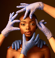 Image showing Portrait, hands and plastic surgery on face of a black woman in studio on a dark background. Transformation, aesthetic or cosmetics and a young person getting ready for change with a team of doctors