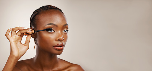 Image showing Mascara, black woman and makeup in studio for beauty, cosmetics and mockup space on brown background. Banner, makeover and brush lashes for skincare application, aesthetic tools and eyelash product
