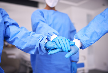 Image showing Doctor, team and hands together for motivation, collaboration or unity in surgery room at hospital. Closeup of medical group piling in teamwork for healthcare planning, trust or support at clinic