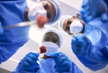 Image showing Patient pov, doctors and surgery in hospital for emergency, healthcare or medical procedure from below. Surgeon, nurse and medic teamwork with face mask, ppe and tools in clinic theater for operation