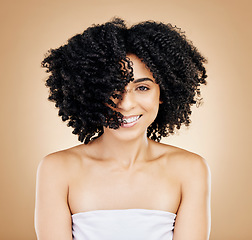 Image showing Hair, curls and portrait of woman, beauty and treatment for shine, cosmetic care and smile on studio background. Wellness, haircare and growth with strong texture and shake locks, volume and afro
