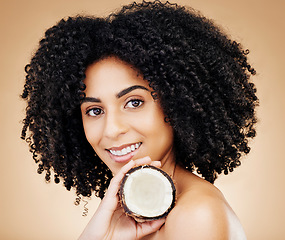 Image showing Woman, portrait and hair, coconut with shine and beauty, organic salon treatment for strong texture on studio background. Face, skin and natural cosmetic product for growth with haircare and fruit