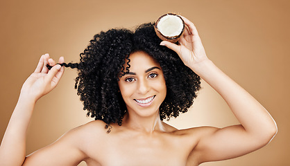 Image showing Woman, hair and coconut in portrait, beauty and product for wellness, oil or cream with cosmetics on studio background. Organic, eco friendly and haircare for growth and strong texture with fruit