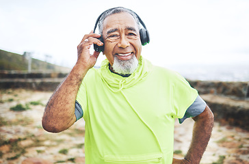 Image showing Happy, headphones and senior man hiking and listening to music, playlist or album for cardio workout. Smile, nature and portrait of elderly male person streaming a song for outdoor trekking in woods.