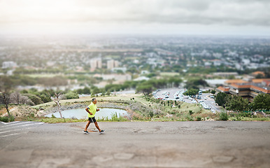 Image showing Hiking, walking or man on road, nature or street for trekking journey or workout with urban path. Aerial, holiday vacation or top view of mature hiker outdoor for exercise, fitness or wellness