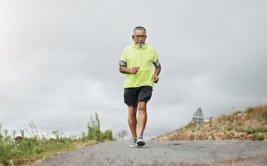 Image showing Senior man, running and road in nature, countryside or forest with exercise for marathon, cardio and health mockup. Fitness, training and person walking on path in workout, sport or run in retirement