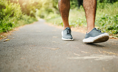 Image showing Man, legs and fitness on road for hiking, workout or walking in outdoor exercise or wellness in nature. Closeup of male person, shoes or feet on path for trekking, training or cardio on asphalt