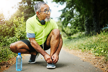 Image showing Senior man, tie and shoes in fitness for running, workout or outdoor exercise on road, nature or asphalt. Mature male person and tying shoe getting ready or preparation for path, cardio or run